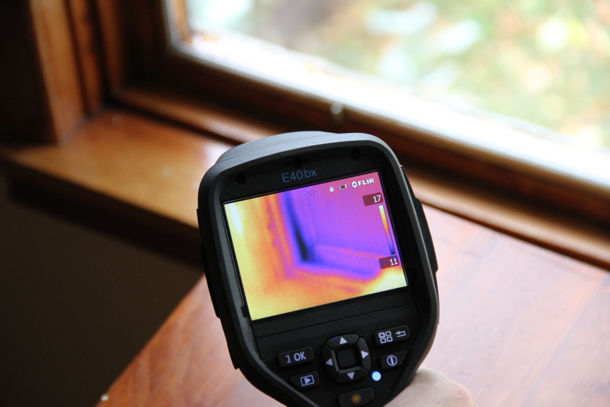 An infrared camera reveals heat leakage around the windows